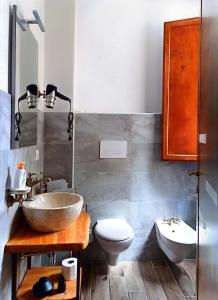 a bathroom with a sink and a toilet at La plaza in Ollolai