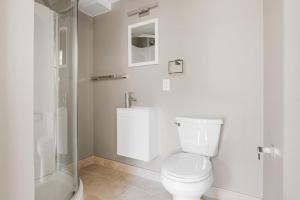 a white bathroom with a toilet and a shower at Beacon Hill studio nr boston common shops BOS-906 in Boston