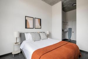 sypialnia z łóżkiem z pomarańczowym kocem w obiekcie Blueground West Loop gym nr Fulton Market CHI-1060 w Chicago