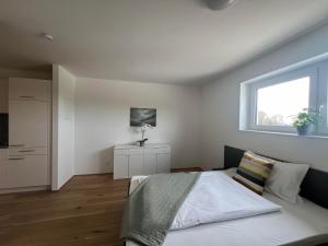 a bedroom with a bed and a window at Stiglechner Tankstelle St. Martin im Mühlkreis 