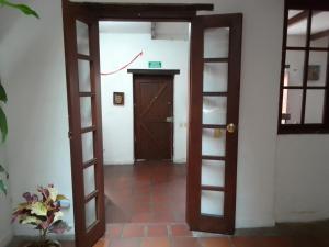 an open door leading to a room with white walls at Ríos Voladores Hostel in Bogotá