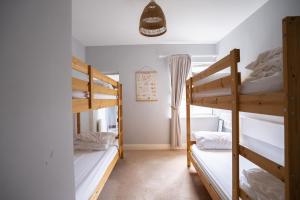 a room with three bunk beds in a house at BigStyle Atlantic Lodge 