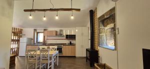 a kitchen with a table and chairs in a room at Quinta do Limite - Casa do Camponês in Covilhã