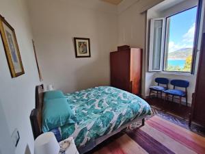 a bedroom with a bed and a large window at Panoramic Apartment in Villa on The Beach, In Center in Agropoli