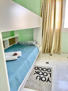 a bedroom with a bed with a blue comforter and a rug at Marble luxury villa in Neápolis
