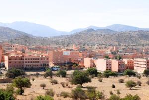 a city in the desert with mountains in the background at Hotel Aladarissa Ait Baha in Aït Taksimt