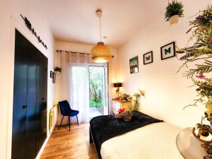 a bedroom with a bed and a large window at Le Chateau in Angers