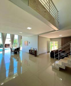 a large living room with a staircase in a house at sobrado luxo in Trindade