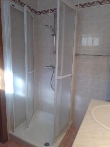 a shower with a glass door in a bathroom at Golfbreker in De Haan +20 photos