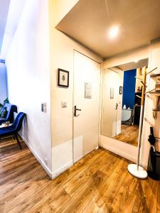 a room with a hallway with a door and wooden floors at Le Chateau in Angers