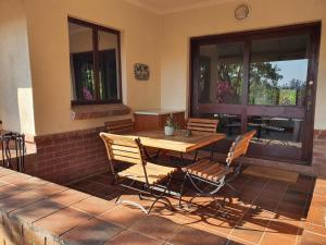 a wooden table and chairs on a patio at Heuglins Lodge in White River