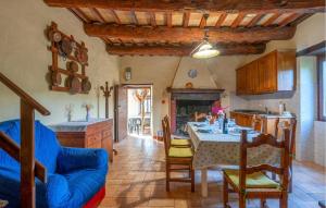 a kitchen with a table and a blue couch at Cafranceschino in Mercatello sul Metauro