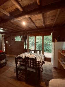 a kitchen with a table and chairs in a room at CABAÑA en Eco Posada Tierra Fértil in Santa Ana