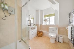 ein Badezimmer mit Toilette, Waschbecken und Dusche in der Unterkunft Live the coastal cottage dream in Dorset AONB in Weymouth