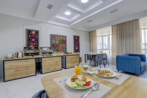 a kitchen with a table with plates of food on it at Aisha Hotel in Bishkek