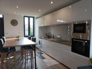 a kitchen with a counter and a table in it at Appartement Caraman in Caraman