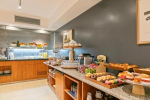 a kitchen with a counter with food on it at Hotel Acta Azul Barcelona in Barcelona