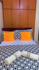 a bed with two pillows on top of it at Studio room entebbe in Entebbe
