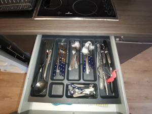 a drawer filled with utensils in a kitchen at n1 F2 40m2 avec petit jardin in Hérouville-Saint-Clair