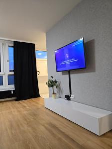 a living room with a flat screen tv on a wall at B&R apartment türkischen Konsulats in Nürnberg
