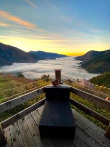 a bench sitting on top of a table with a view of clouds at Les 3 Flocons Roure in Roure