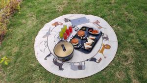 a picnic table with a plate of food on it at Adaara Retreat - Pet Friendly Cottages, Almora in Almora