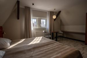 Posteľ alebo postele v izbe v ubytovaní Ołowianka B&B
