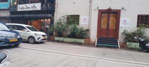 ein weißes Auto, das vor einem Gebäude parkt in der Unterkunft Shine Hospitality Group in Mumbai