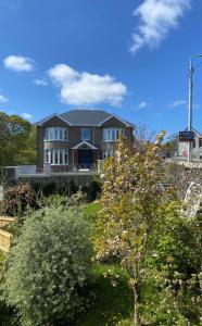 a large house on top of a hill with trees at Carrick Gate in Carrick
