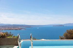 a swimming pool with a view of a body of water at Omnia Luxury Villas in Chania Town