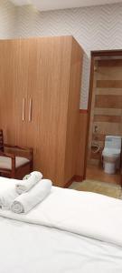 a bedroom with a bed and a bathroom with a toilet at Waterlily Homestay in Kottayam
