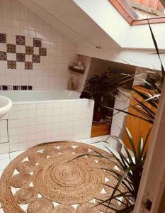 a bathroom with a bath tub and a rug at Superbe duplex loft au coeur de Paris in Paris