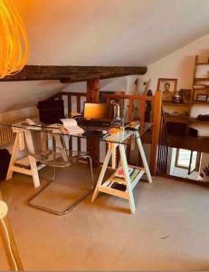 a room with a desk with a laptop on it at Superbe duplex loft au coeur de Paris in Paris