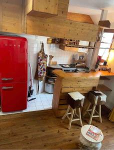 a kitchen with a red refrigerator and a counter at Superbe duplex loft au coeur de Paris in Paris