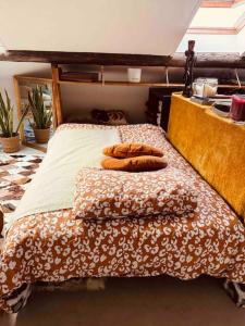a bed with two pillows on top of it at Superbe duplex loft au coeur de Paris in Paris