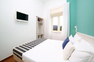 a white bedroom with a bed and a window at Hotel Royal Hills in Piano di Sorrento +73 photos