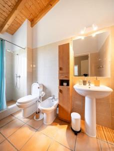 a bathroom with a toilet and a sink at Seashore Escape in Aljezur