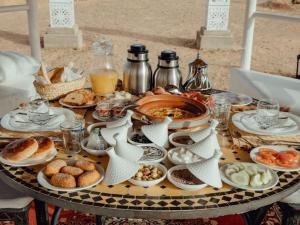a table with plates of food on top of it at Global Luxury Camp in Merzouga