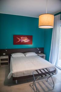 a bedroom with a bed and a green wall at Casa Consani in Ventimiglia