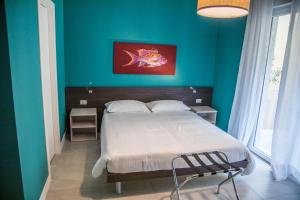 a bedroom with a bed and a blue wall at Casa Consani in Ventimiglia