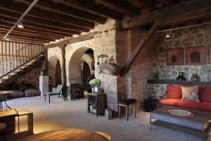 ein Wohnzimmer mit einer Couch und einer Backsteinwand in der Unterkunft Emebed Posada in Castrojeriz
