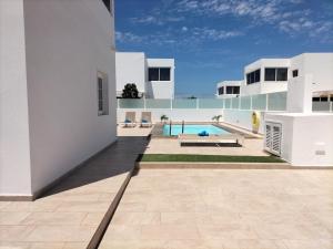 a view of a house with a swimming pool at LUXURY RUBICON Jacuzzi y Piscina in Playa Blanca