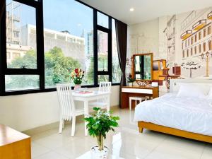 um quarto com uma cama, uma mesa e cadeiras em Kem Apartment 18 Ngô Quyền em Hanói