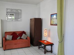 三河市Villa SaFran - Appartement Trois-Rivières的客厅里有一张红色的沙发和一张桌子