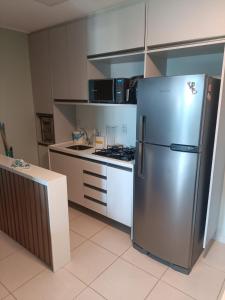a kitchen with a stainless steel refrigerator at Cupe Beach Living Concept 304E in Porto De Galinhas