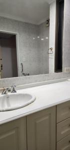 y baño con lavabo blanco y espejo. en Nueva Cordoba en Córdoba