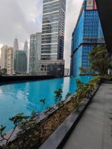 a swimming pool in a city with tall buildings at ASTRA @ 8 Kia Peng Suites in Kuala Lumpur