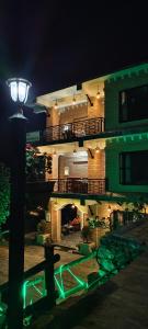 a building at night with a green light on it at Hotel Garangja in Bandipur