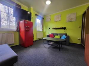 a living room with a red refrigerator and a couch at Ubytování pod Pradědem - Karlov pod Pradědem in Bruntál