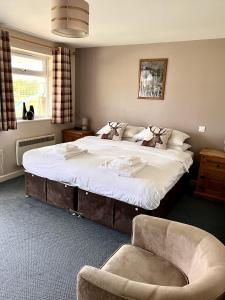a bedroom with a large bed and a chair at The Malt Shovel Inn in Bridgwater